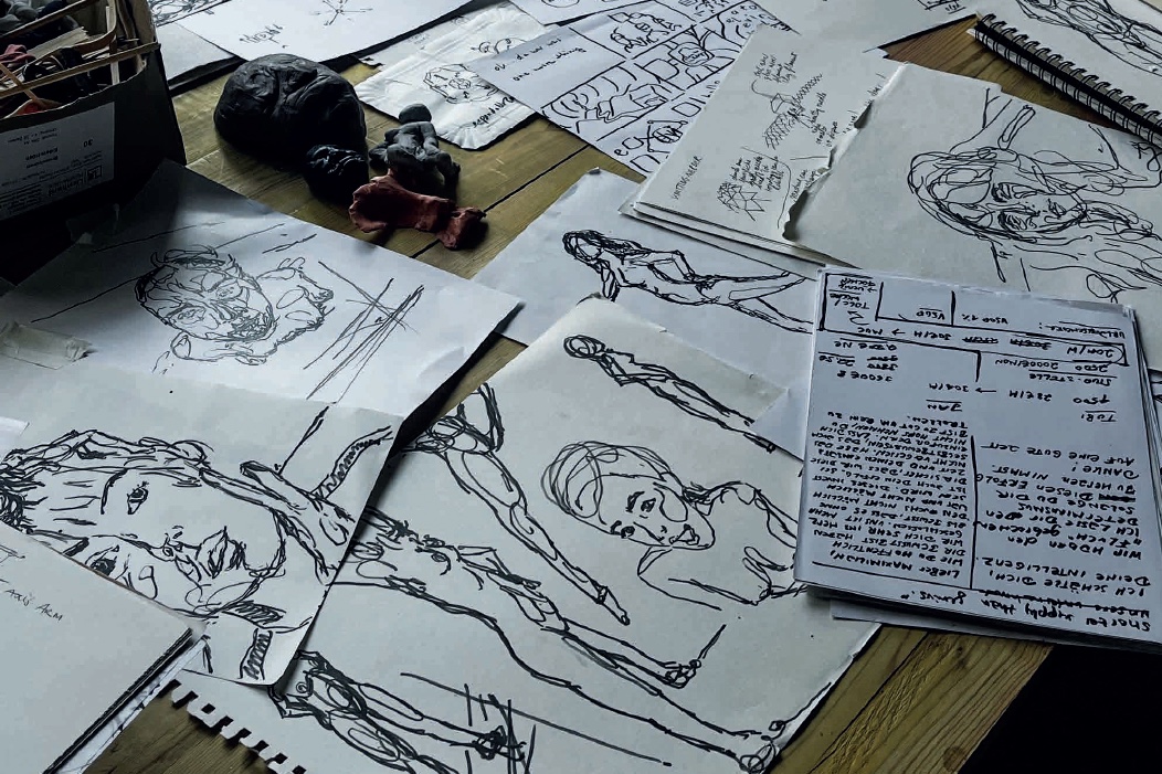 The room; the easel, Blackwell the printing press and her ink; the pinboard; the table with sketches.